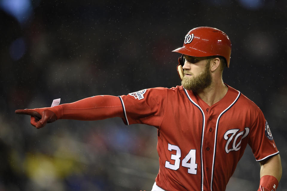 Washington Nationals' Bryce Harper points to the dugout after he hit his two-run home run during the seventh inning of the second baseball game of a doubleheader against the Chicago Cubs, Saturday, Sept. 8, 2018, in Washington. (AP Photo/Nick Wass)