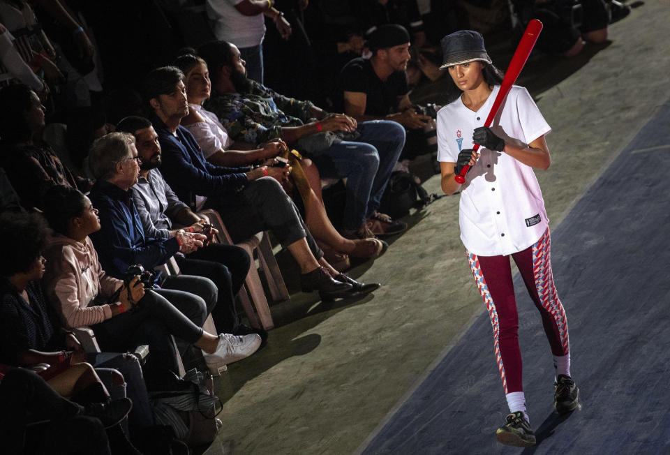 A model wears a creation from "Clandestina," the first Cuban independent urban fashion brand, during a launch for the 2020 collection called Sports Glories in Havana, Cuba, Friday, Nov. 22, 2019. (AP Photo/Ramon Espinosa)