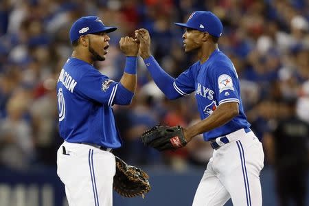 Toronto Blue Jays first baseman Edwin Encarnacion (10) and left fielder Melvin Upton Jr. (7) celebrate beating the Cleveland Indians in game four of the 2016 ALCS playoff baseball series at Rogers Centre. Mandatory Credit: John E. Sokolowski-USA TODAY Sports