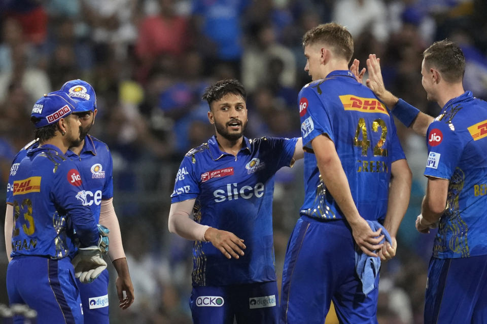 Mumbai Indians' Akash Madhwal, center, celebrates with teammates the wicket of Gujrat Titans' David Miller during the Indian Premier League cricket match between Mumbai Indians and Gujrat Titans in Mumbai, India, Friday, May 12, 2023. (AP Photo /Rajanish Kakade)