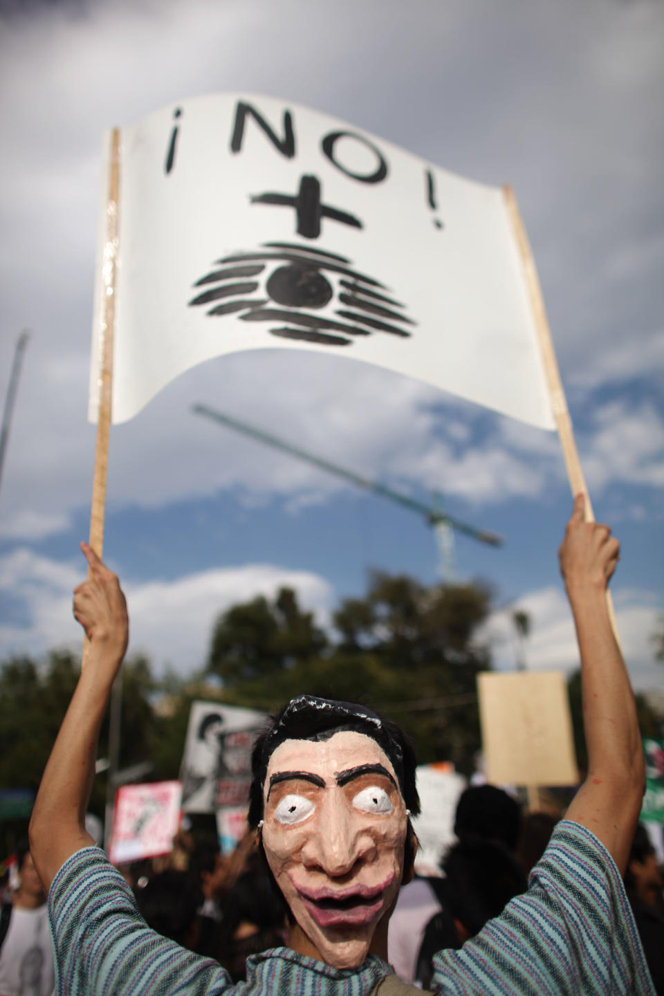 A student holds signs during a demonstration to protest a possible return of the old ruling Institutional Revolutionary Party (PRI) and against what they perceive as a biased coverage by major Mexican TV networks directed in favor of PRI's candidate Enrique Pena Nieto in Mexico City, Wednesday, May 23, 2012. Mexico will hold presidential elections on July 1. The banner reads in Spanish "No More Televisa". Mexico will hold presidential elections on July 1. (AP Photo/Alexandre Meneghini)