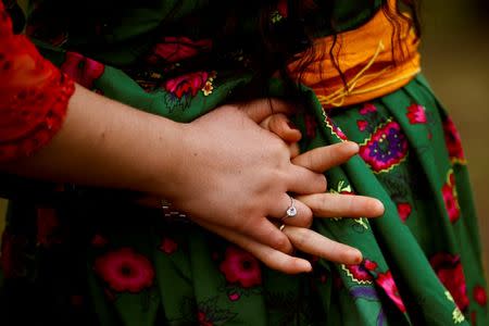 Kurdish women hold hands as they dance during Newroz celebrations in a public park in Warabi, north of Tokyo, March 20, 2016. REUTERS/Thomas Peter