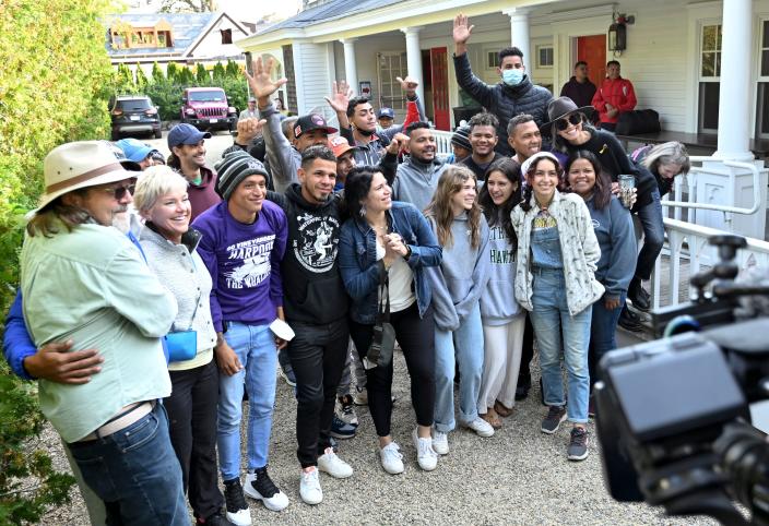 Migrants who landed on Sept. 14 on Martha's Vineyard gather with island volunteers who helped them with food and lodging, prior to the migrants, who were mostly Venezuelan, left for Cape Cod.