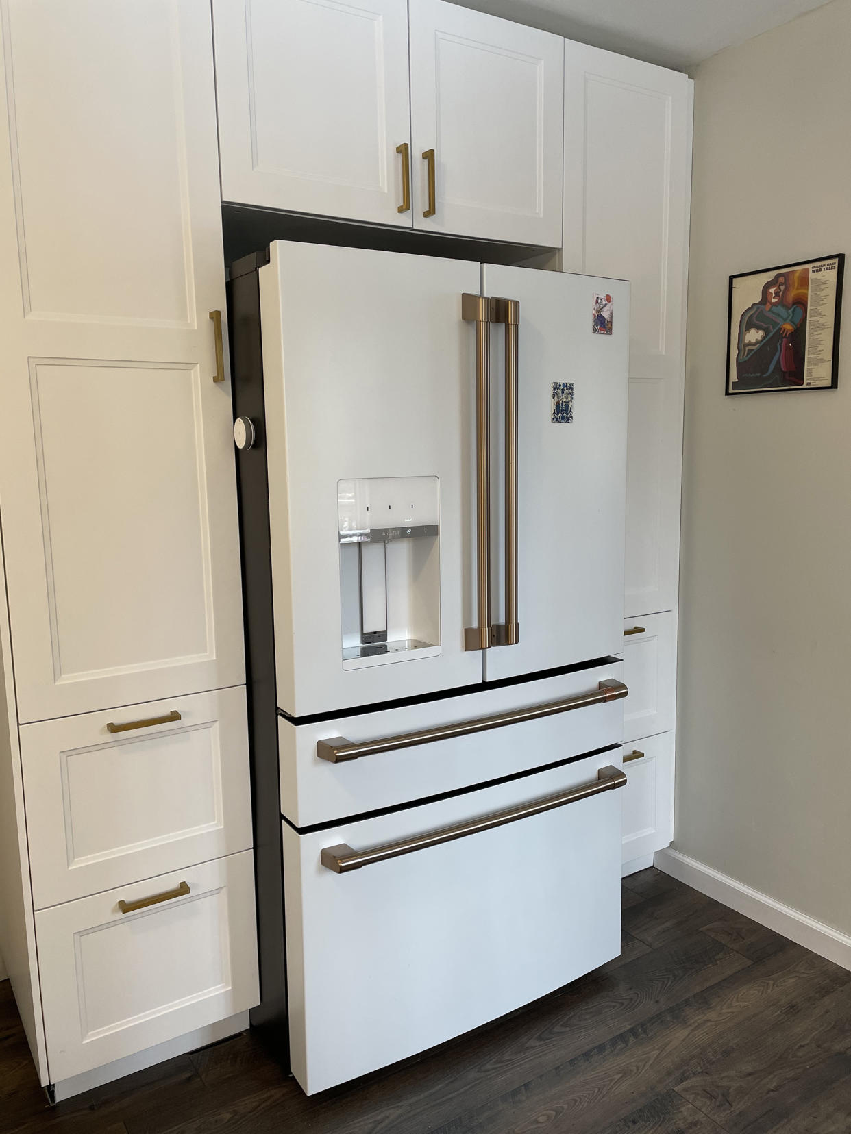 The French Door refrigerator from Cafe in white with brushed bronze accents flows effortlessly with the built-in pantry surrounding it.  (Erica Chayes Wida)