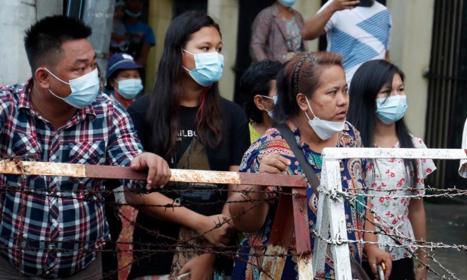 People wait for the release of their family member from Insein prison in Yangon.