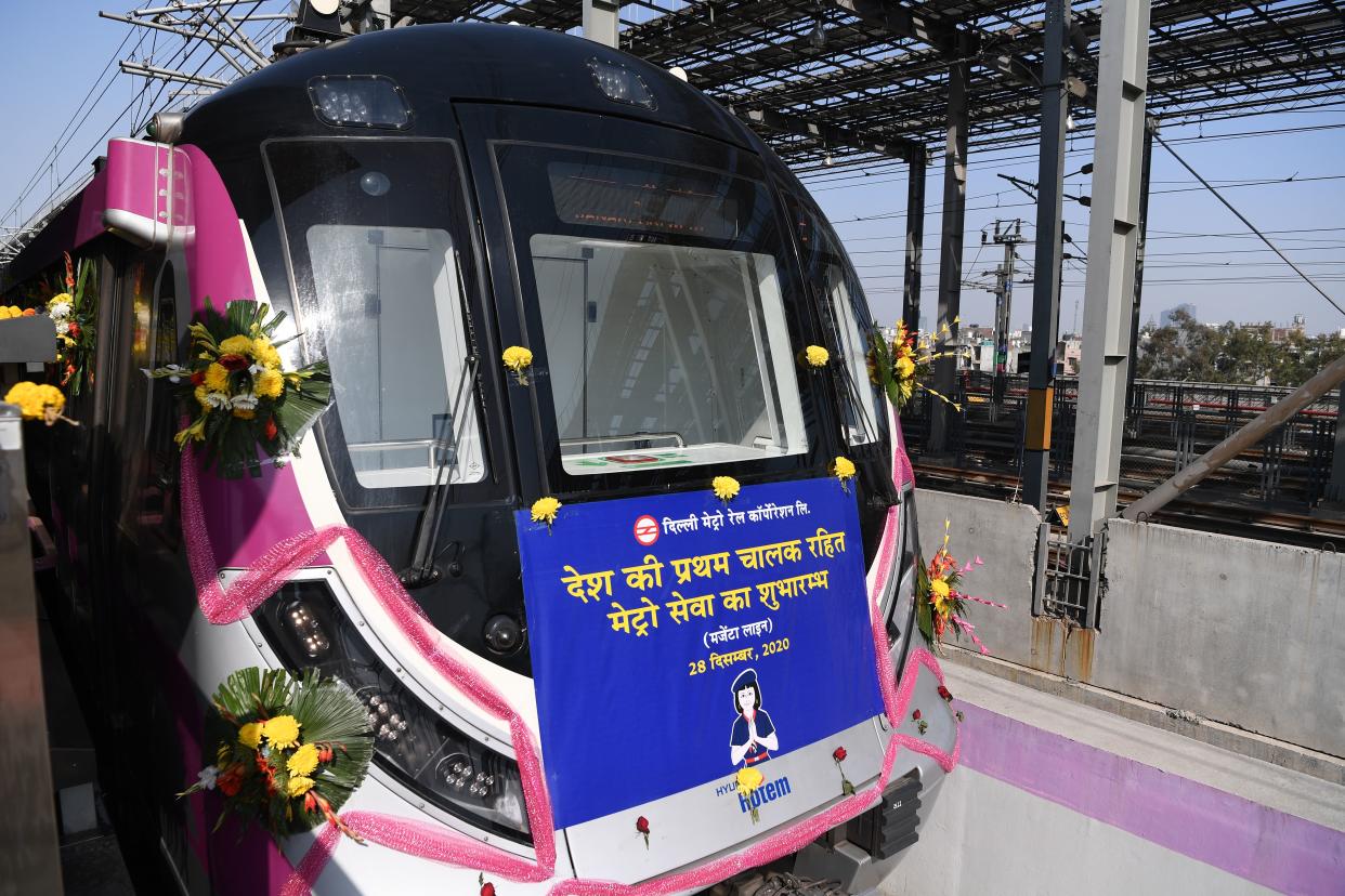 <p>Flowers adorn the front of India’s first driverless metro train at a station during its inauguration in New Delhi on December 28, 2020</p> (AFP via Getty Images)