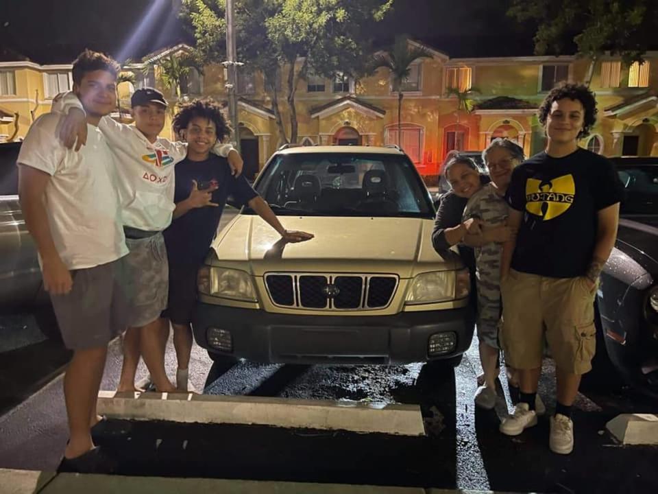 Michelle Delgado, third from the right, is pictured Aug. 25 after receiving an SUV from The Legacy Closet.