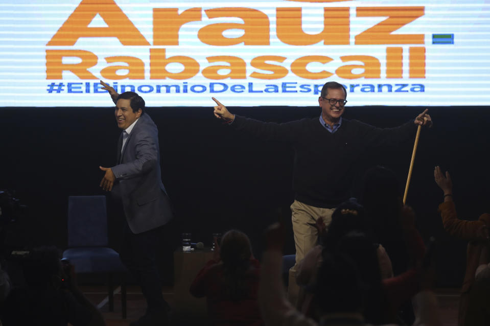 Esperanza-UNES- alliance party presidential candidate Andres Arauz, left, and his running mate Carlos Rabascall celebrate as they wait for the official results to know if they have reached the necessary percentage to win in the first electoral round, in Quito, Ecuador, Sunday, Feb. 7, 2021. (AP Photo/Dolores Ochoa)