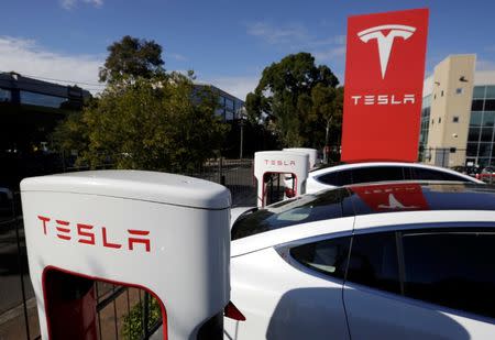 Tesla Model X cars are charged by superchargers at a Tesla electric car dealership in Sydney, Australia, May 31, 2017. REUTERS/Jason Reed/Files