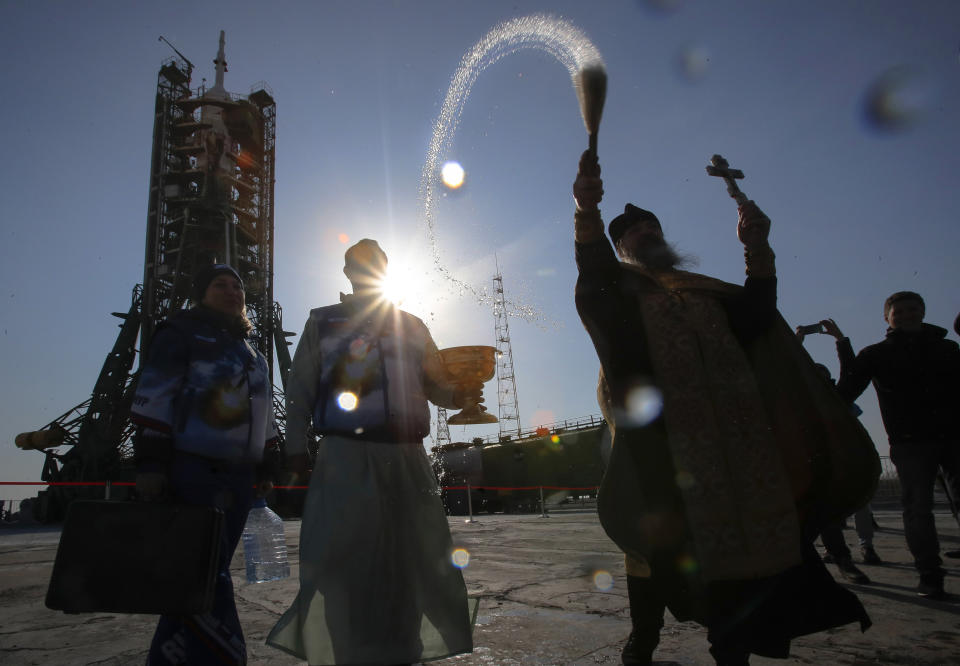 An Orthodox priest conducts a blessing service in front of the Soyuz FG rocket at the Russian leased Baikonur cosmodrome, Kazakhstan, Thursday, March 14, 2019. The new Soyuz mission to the International Space Station (ISS) is scheduled on Thursday, March 14 with U.S. astronauts Christina Hammock Koch, Nick Hague, and Russian cosmonaut Alexey Ovchinin. (AP Photo/Dmitri Lovetsky)