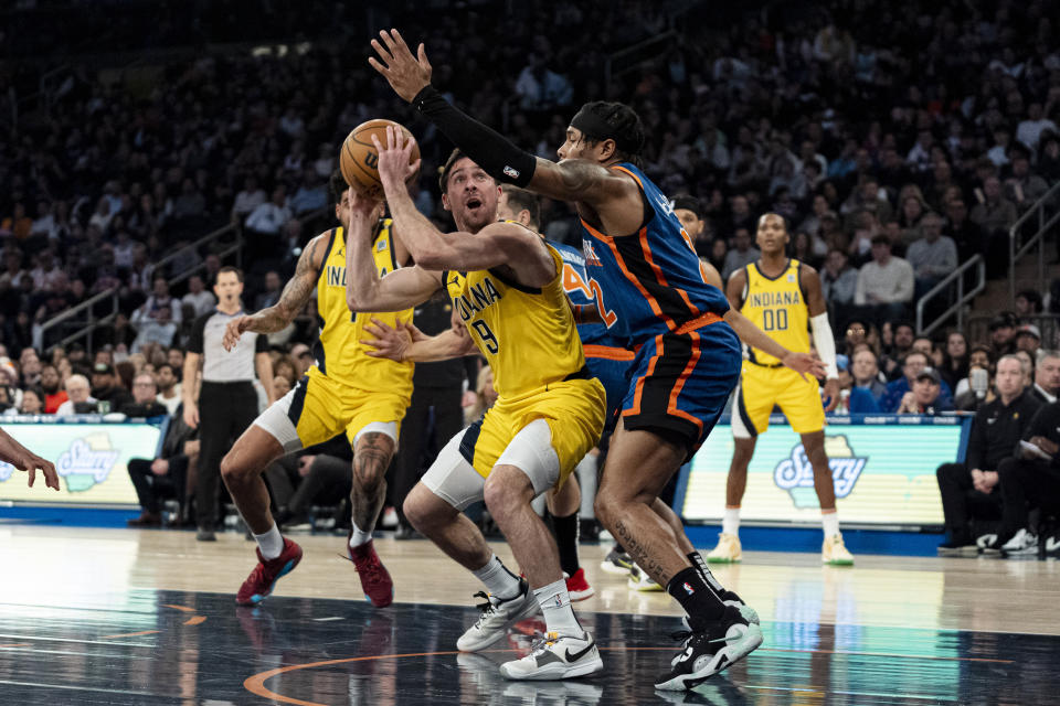 Indiana Pacers guard T.J. McConnell (9) is defended by New York Knicks guard Miles McBride (2) during the first half of an NBA basketball game in New York, Saturday, Feb. 10, 2024. (AP Photo/Peter K. Afriyie)