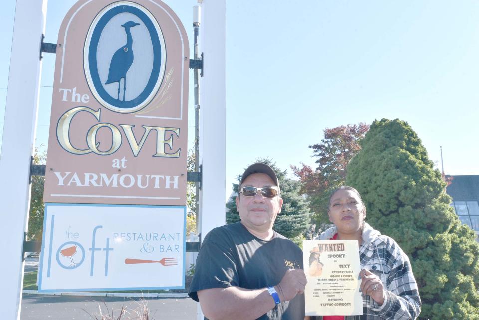 Mashpee Wampanoag Tribe members Darius and Eleanor Coombs hold a poster on Oct. 28 about a western-themed Halloween party at The Loft restaurant at the Cove in West Yarmouth. The couple stayed at the inn for the weekend and protested with management about the party theme that included an invitation to dress in costume as "Indians & Chiefs."