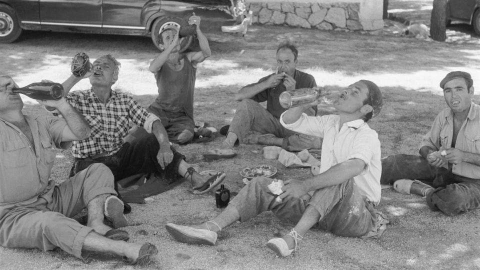 Siestas began as a traditional break for workers to avoid the intense heat of the midday sun, like these men pictured in the 1950s. - Erich Andres/United Archives/Getty Images