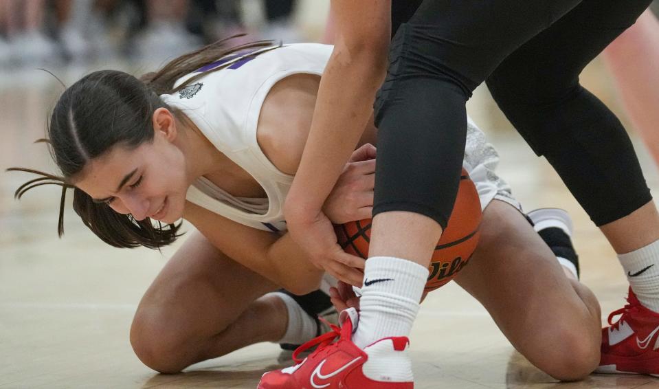 Brownsburg Bulldog Elle McCulloch (14) struggles to hold onto the ball Saturday, Feb. 11, 2023, during IHSAA 4A regionals at Decatur Central in Indianapolis. Lawrence North defeated Brownsburg, 65-58, advancing to semi-state. 