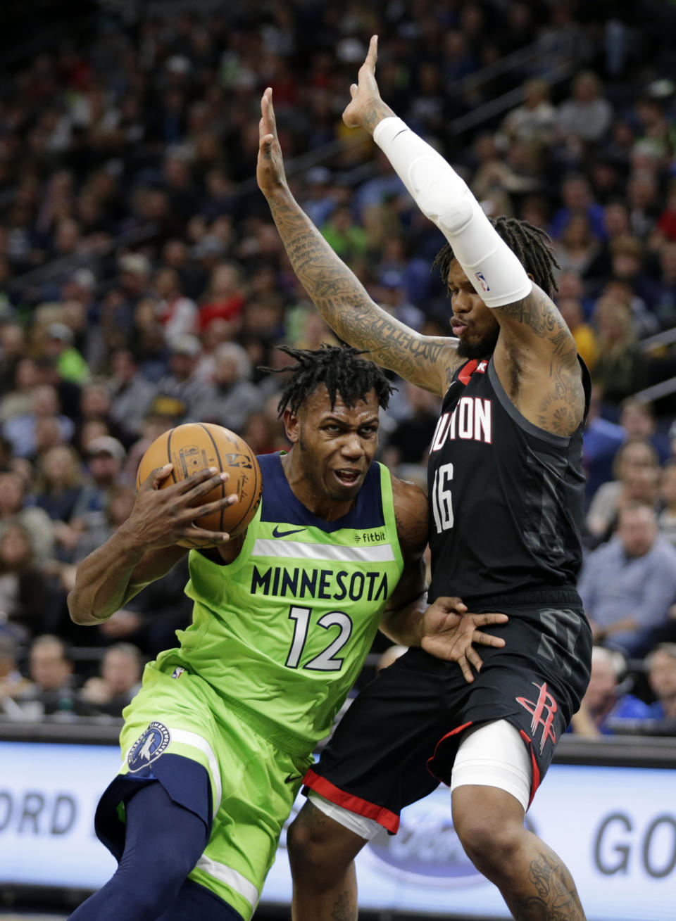 Minnesota Timberwolves guard Trevion Graham (12) drives on Houston Rockets guard Ben McLemore (16) in the first quarter during an NBA basketball game Saturday, Nov. 16, 2019 in Minneapolis. (AP Photo/Andy Clayton- King)