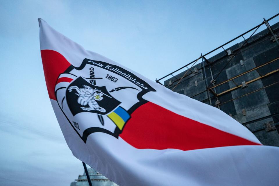 A soldier waves the flag of Kastus Kalinouski Regiment during a rally at Sofia Square on March 14, 2023, in Kyiv, Ukraine. (Photo by Oleksii Samsonov /Global Images Ukraine via Getty Images)