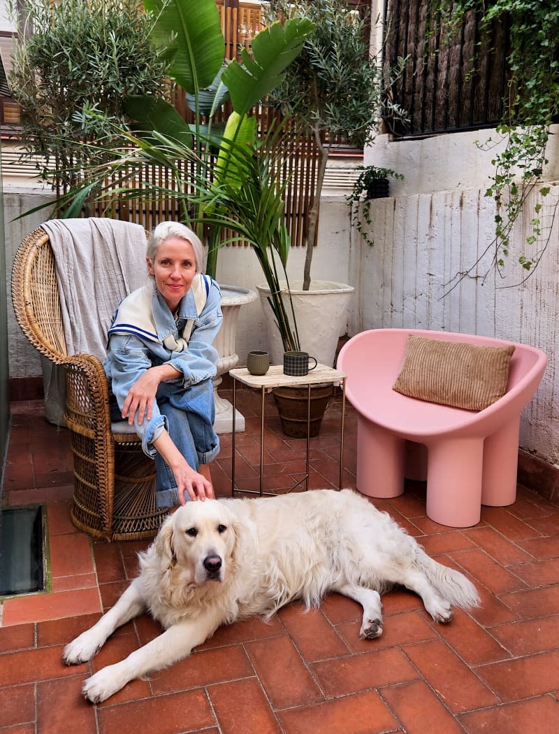 Dweller poses outside their apartment with their dog.
