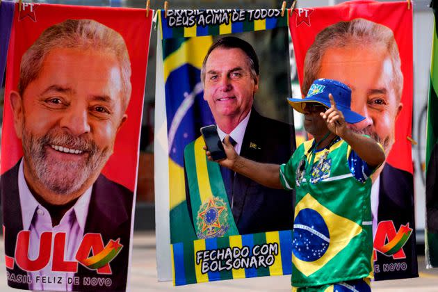 Nearly a dozen candidates are running in Brazil’s presidential election but only two stand a chance of reaching a runoff: former President Luiz Inácio Lula da Silva (whose image appears at left) and incumbent Jair Bolsonaro (whose image appears in the center). (Photo: (AP Photo/Eraldo Peres))