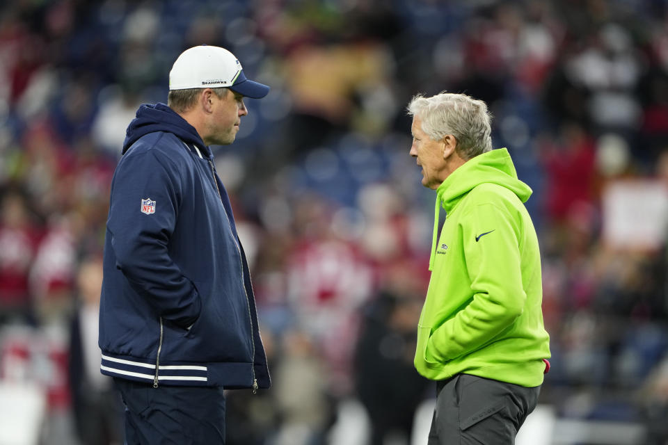Seattle Seahawks offensive coordinator Shane Waldron, left, talks with head coach Pete Carroll before an NFL football game against the San Francisco 49ers, Thursday, Nov. 23, 2023, in Seattle. (AP Photo/Lindsey Wasson)