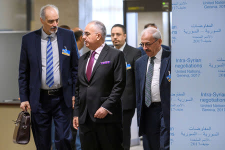 Syrian chief negotiator and Ambassador of the Permanent Representative Mission of Syria to the United Nations Bashar al-Jaafari (L) and his delegation arrives to a meeting during Syria peace talks in Geneva, Switzerland March 25, 2017. REUTERS/Fabrice Coffrini/Pool