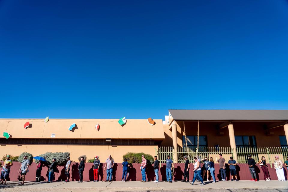 People wait in line to vote at a polling station at the Woods Memorial Library in Tucson on Nov. 8, 2022.