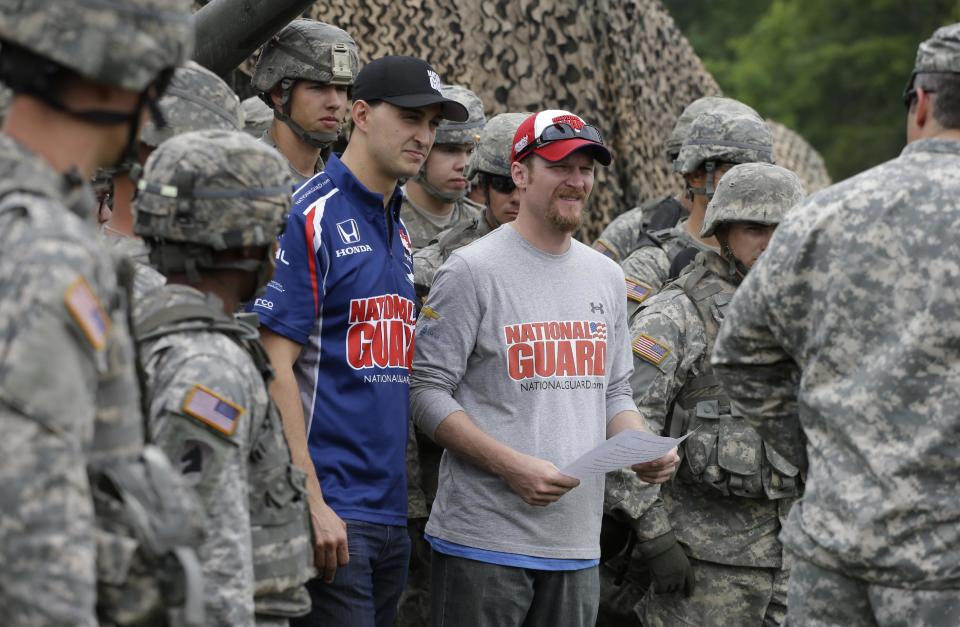 NASCAR driver Dale Earnhardt Jr., right, and IndyCar driver Graham Rahal talk to the soldiers at Camp Atterbury Wednesday, July 23, 2014, in Edinburgh, Ind. (AP Photo/Darron Cummings)