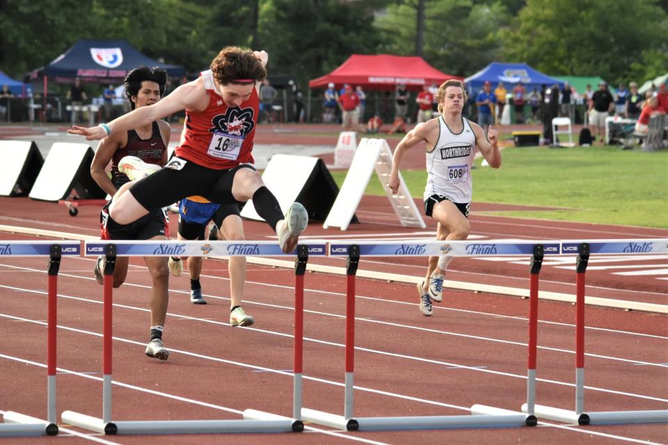 Zane Thompson soars over his final hurdle during the 300-meter hurdles at the 2022 IHSAA Boys' Track and Field State Finals.