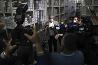 Caretaker Health Minister Hamad Hassan, speaks to journalists during his visit to a medical warehouse in Beirut, Lebanon, Friday, June 11, 2021. Hassan raids warehouses in an effort to control those who are hoarding subsidized medical equipment and baby formula in order to sell them later at higher prices or on the black market. (AP Photo/Bilal Hussein)