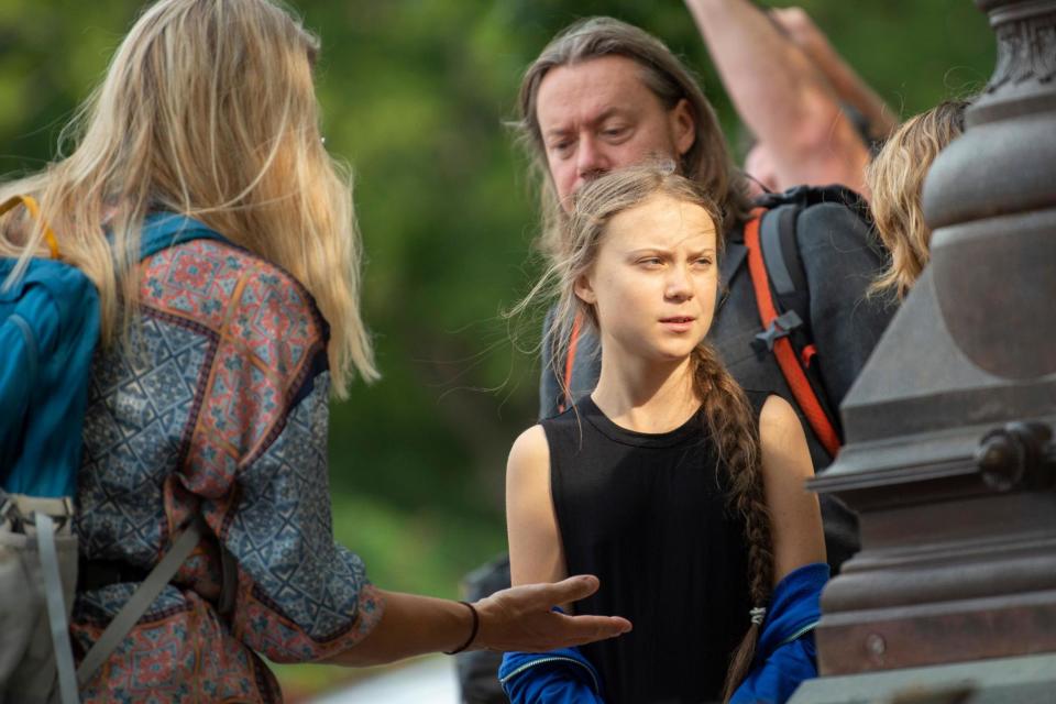 Greta Thunberg (C) talks with members of her close entourage as she takes part in a media event on Capitol Hill (AFP/Getty Images)