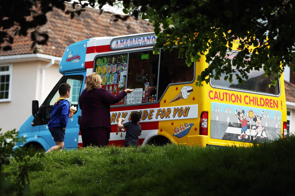 A family stop to buy an ice cream from an ice-cream van at Hove Park, near Brighton, as the UK continues in lockdown to curb the spread of Coronavirus during the pandemic.