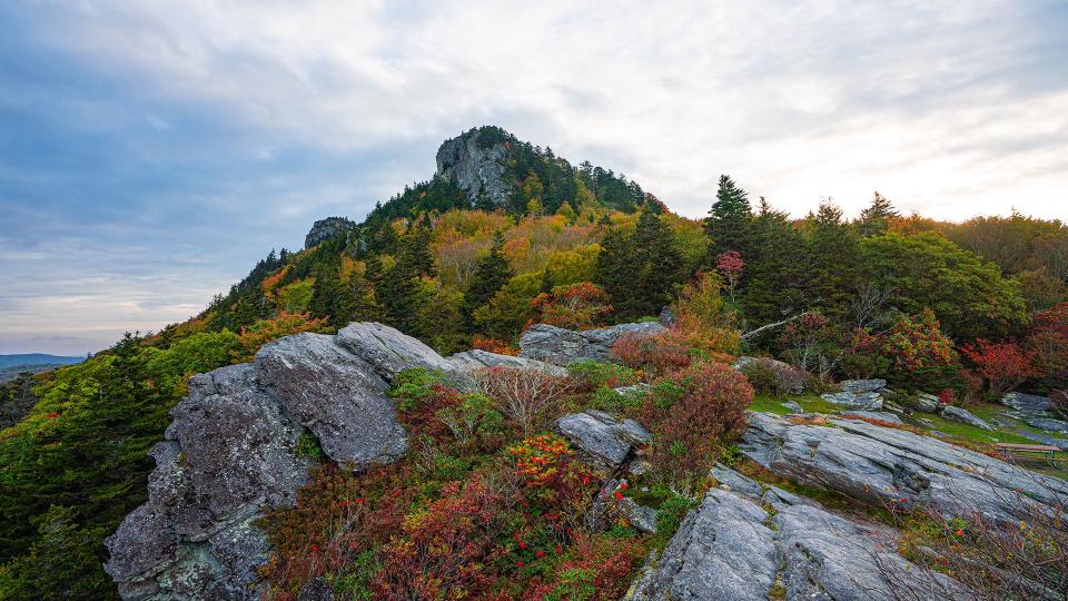 Oct. 13, 2023: Cliffside Picnic Area and Overlook provides this unique vantage point looking up at Linville Peak, with fall foliage and the rich red hue of mountain ash berries brightening up the shot. This spot is just one of a dozen picnic areas in the park. These sites are located in some of the mountain’s most picturesque settings and offer an array of scenic views.