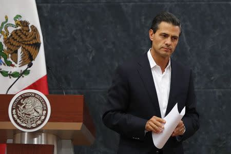 Mexico's President Enrique Pena Nieto looks on after addressing the media about a private meeting with the relatives of the 43 missing students of Ayotzinapa Teacher Training College Raul Isidro Burgos, at Los Pinos presidential residence in Mexico City in this October 29, 2014 file photo. REUTERS/Bernardo Montoya/Files