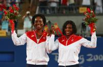 <p>Venus Williams (L) and Serena Williams of the United States celebrate the gold medal after defeating Virginia Ruano Pascual and Anabel Medina Garrigues of Spain in the Women’s Doubles gold medal match held at the Olympic Green Tennis Center during Day 9 of the Beijing 2008 Olympic Games on August 17, 2008 in Beijing, China. The Williams sisters won the gold medal. (Photo by Clive Brunskill/Getty Images) </p>