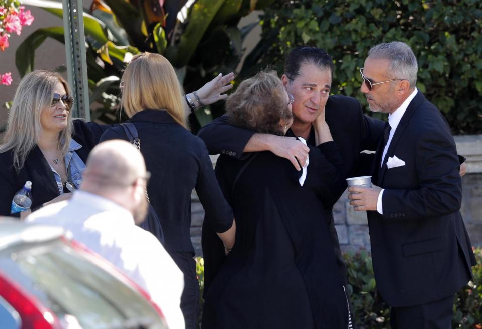 Family and friends embrace at the funeral (AP)