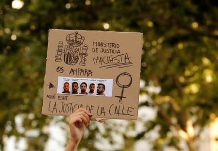 FILE PHOTO: A protester holds a sign during a demonstration against the release on bail of five men known as the "Wolf Pack" cleared of gang rape of a teenager and convicted of a lesser crime of sexual abuse in Seville