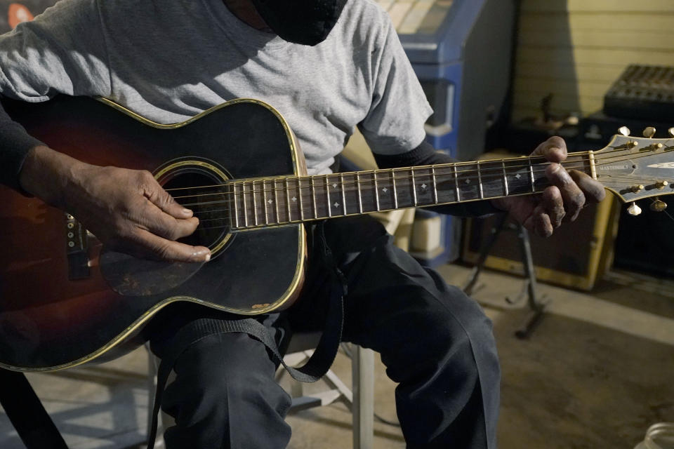 Blues performer Jimmy "Duck" Holmes plays a quick ditty at the Blue Front Cafe in Bentonia, Miss., Jan. 21, 2021. Holmes' ninth album, "Cypress Grove," has earned a Grammy nomination for the Best Traditional Blues Album. (AP Photo/Rogelio V. Solis)