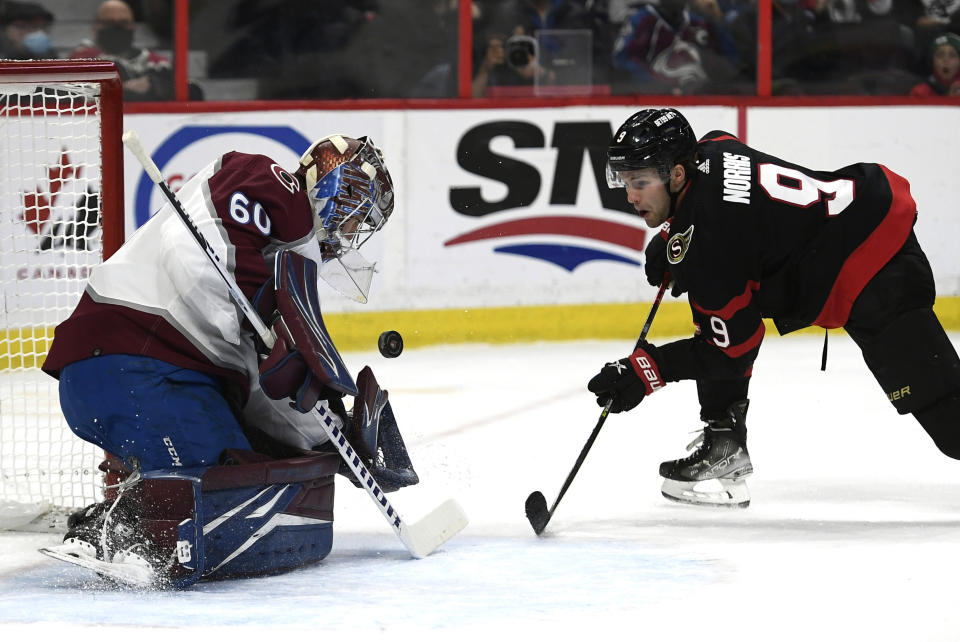 Ottawa Senators centre Josh Norris (9) watches his shot rebound off the chest of Colorado Avalanche goaltender Justus Annunen (60) during the second period of an NHL hockey game Saturday, Dec. 4, 2021, in Ottawa, Ontario. (Justin Tang/The Canadian Press via AP)