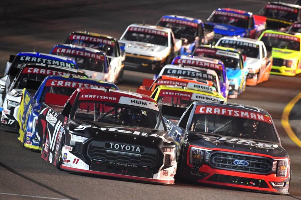 Nov 3, 2023; Avondale, Arizona, USA; NASCAR Gander RV and Outdoors Truck Series driver Corey Heim (11) and NASCAR Gander RV and driver Ty Majeski (98) lead the field for the restart of during the Truck Series Championship at Phoenix Raceway.