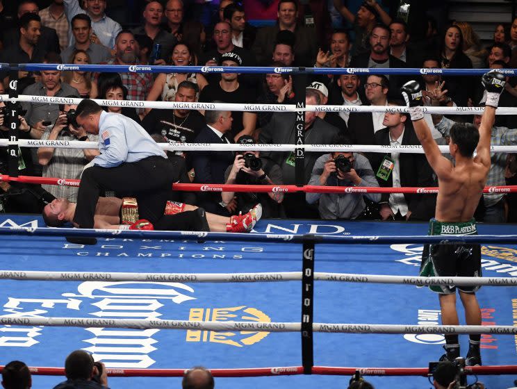 Mikey Garcia (R) celebrates as referee Tony Weeks checks on Dejan Zlaticanin after Garcia knocked him out in the fourth round of the WBC lightweight title fight Jan. 28 in Las Vegas. Garcia will next fight Adrien Broner on July 29. (Getty Images)