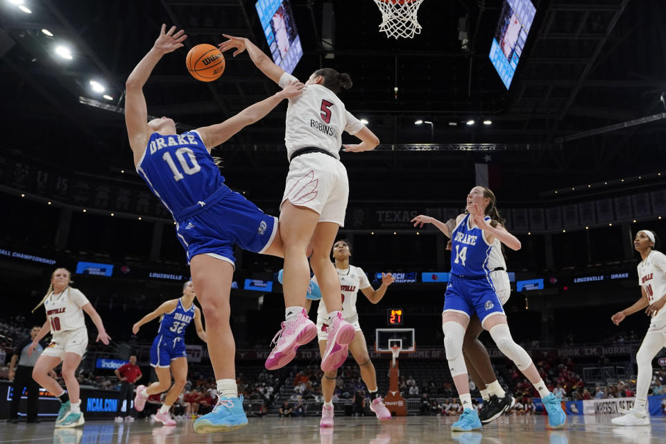 Drake guard Katie Dinnebier (10) is blocked by Louisville guard Mykasa Robinson (5) as she drives to the basket during the second half of a first-round college basketball game in the NCAA Tournament in Austin, Texas, Saturday, March 18, 2023. (AP Photo/Eric Gay)