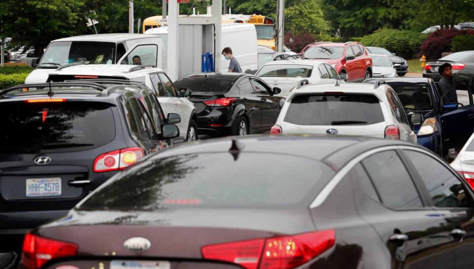 Customers line up to get gas at the Mobil station on S. Saunders Street in Raleigh, N.C. Wednesday, May 12, 2021. The station was the only one in the area that had gas available.