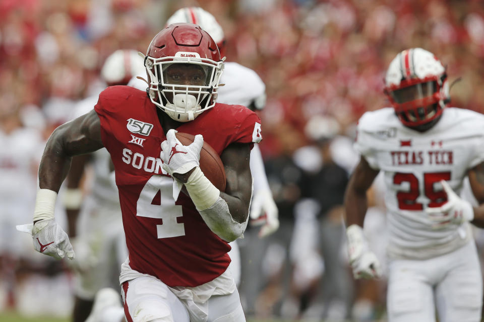 Oklahoma running back Trey Sermon (4) carries for a touchdown in front of Texas Tech defensive back Dadrion Taylor (25) in the third quarter of an NCAA college football game in Norman, Okla., Saturday, Sept. 28, 2019. (AP Photo/Sue Ogrocki)