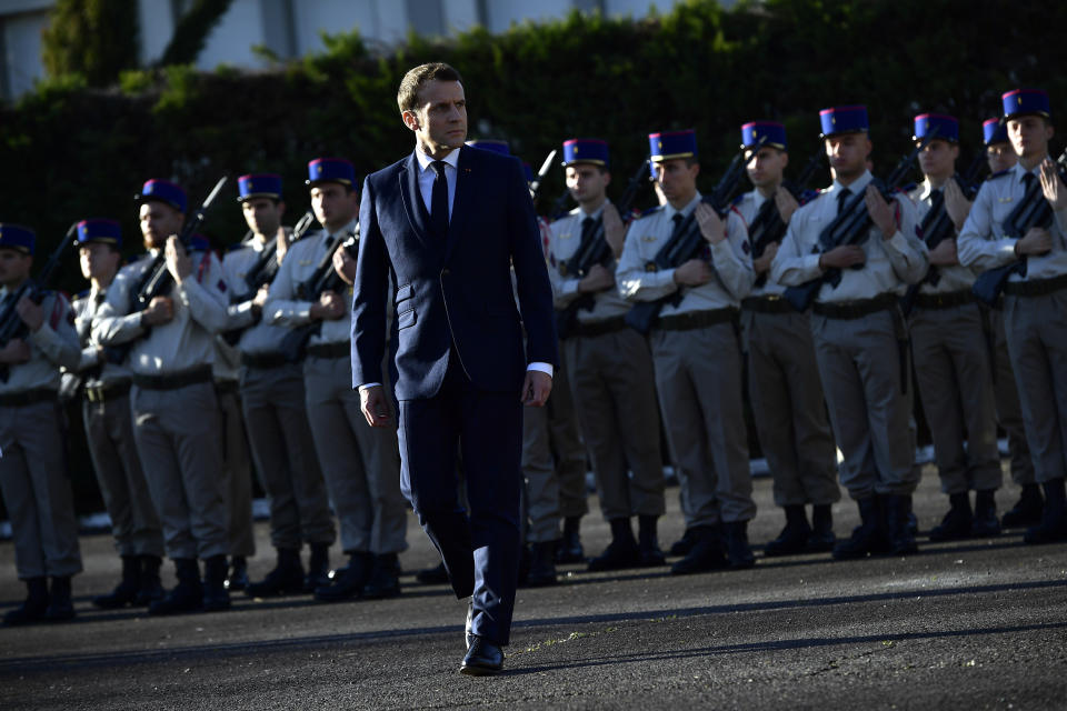 French President Emmanuel Macron reviews troops as he pays tribute to French soldiers who died in Mali helicopter crash, Monday Jan.13, 2020 in Pau, southwestern France. France is preparing its military to better target Islamic extremists in a West African region that has seen a surge of deadly violence. (AP Photo/Alvaro Barrientos, Pool)