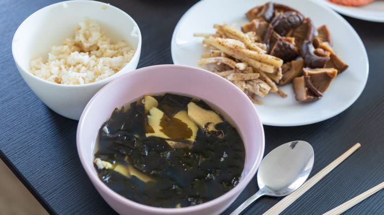 A Korean meal with banchan, rice, and mushrooms