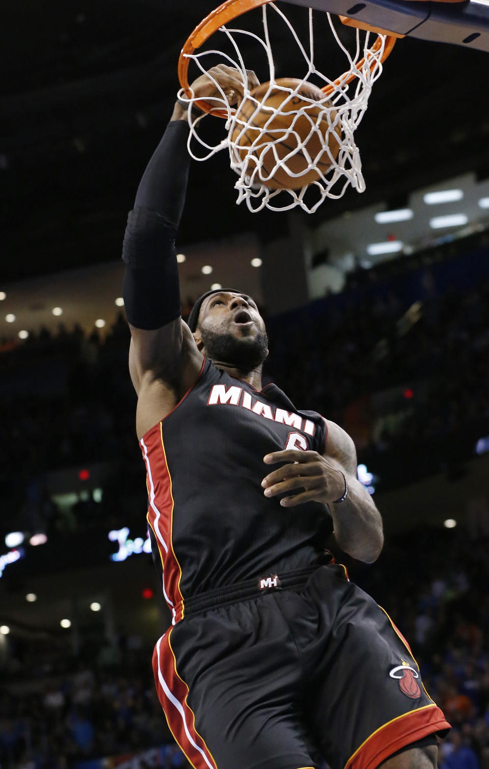 Miami Heat forward LeBron James (6) dunks during the first quarter of an NBA basketball game against the Oklahoma City Thunder in Oklahoma City, Thursday, Feb. 20, 2014. (AP Photo/Sue Ogrocki)