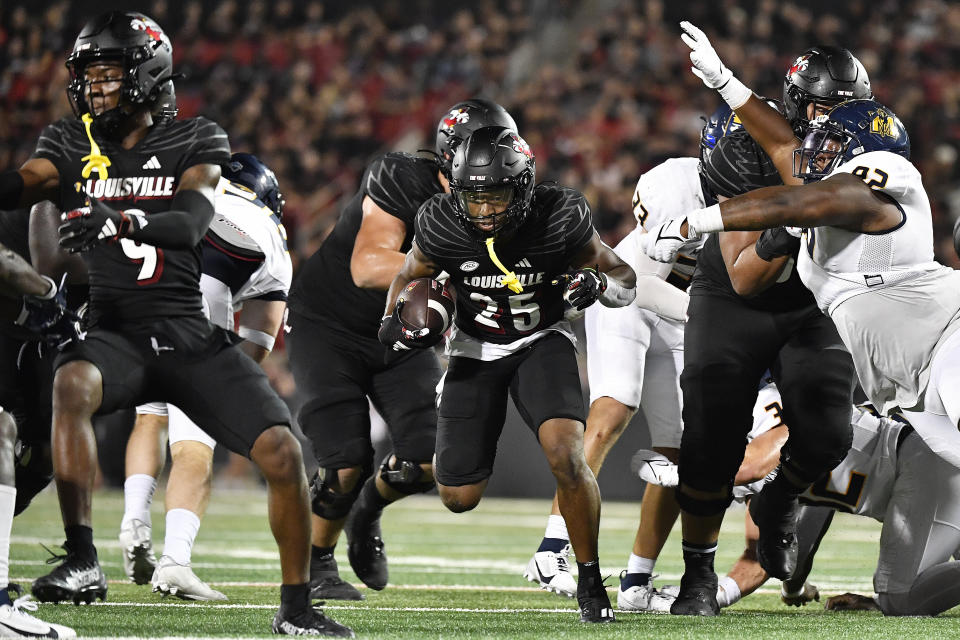 Louisville running back Jawhar Jordan (25) breaks through the Murray State line during the second half of an NCAA college football game in Louisville, Ky., Thursday, Sept. 7, 2023. (AP Photo/Timothy D. Easley)