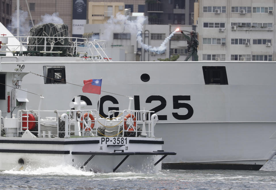 Crew members of the Taiwan Coast Guard perform during an offshore anti-terrorism drill outside the Kaohsiung harbor in Kaohsiung, southwestern Taiwan, Saturday, June 10, 2023. During Saturday's drills, Taiwanese security officers demonstrated how they would defend against terrorist acts at sea.(AP Photo/Chiang Ying-ying)