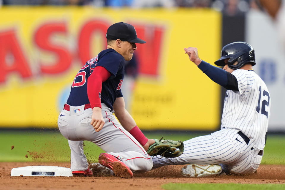 Boston Red Sox's Enrique Hernandez, left, tags out New York Yankees' Isiah Kiner-Falefa on a stolen-base attempt during the second inning of a baseball game Friday, June 9, 2023, in New York. (AP Photo/Frank Franklin II)