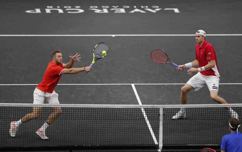 Team World's John Isner, right, and Jack Sock play Team Europe's Roger Federer and Alexander Zverev in a men's doubles tennis match at the Laver Cup, Sunday, Sept. 23, 2018, in Chicago. (AP Photo/Jim Young)
