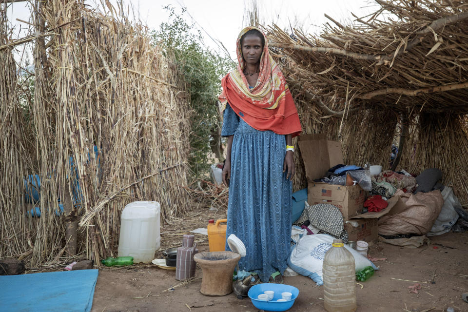 Ethiopian Tigrayan refugee 27-year-old Aksamaweet Garazgerer, who is living with HIV, stands in front of her temporary shelter at Umm Rakouba refugee camp in Qadarif, eastern Sudan, Monday, Dec. 7, 2020. Garazgerer has lived with HIV for the last 14 years and a trip to the clinic is a daily occurrence since she got to the camp searching for antiretroviral medication for HIV. (AP Photo/Nariman El-Mofty)